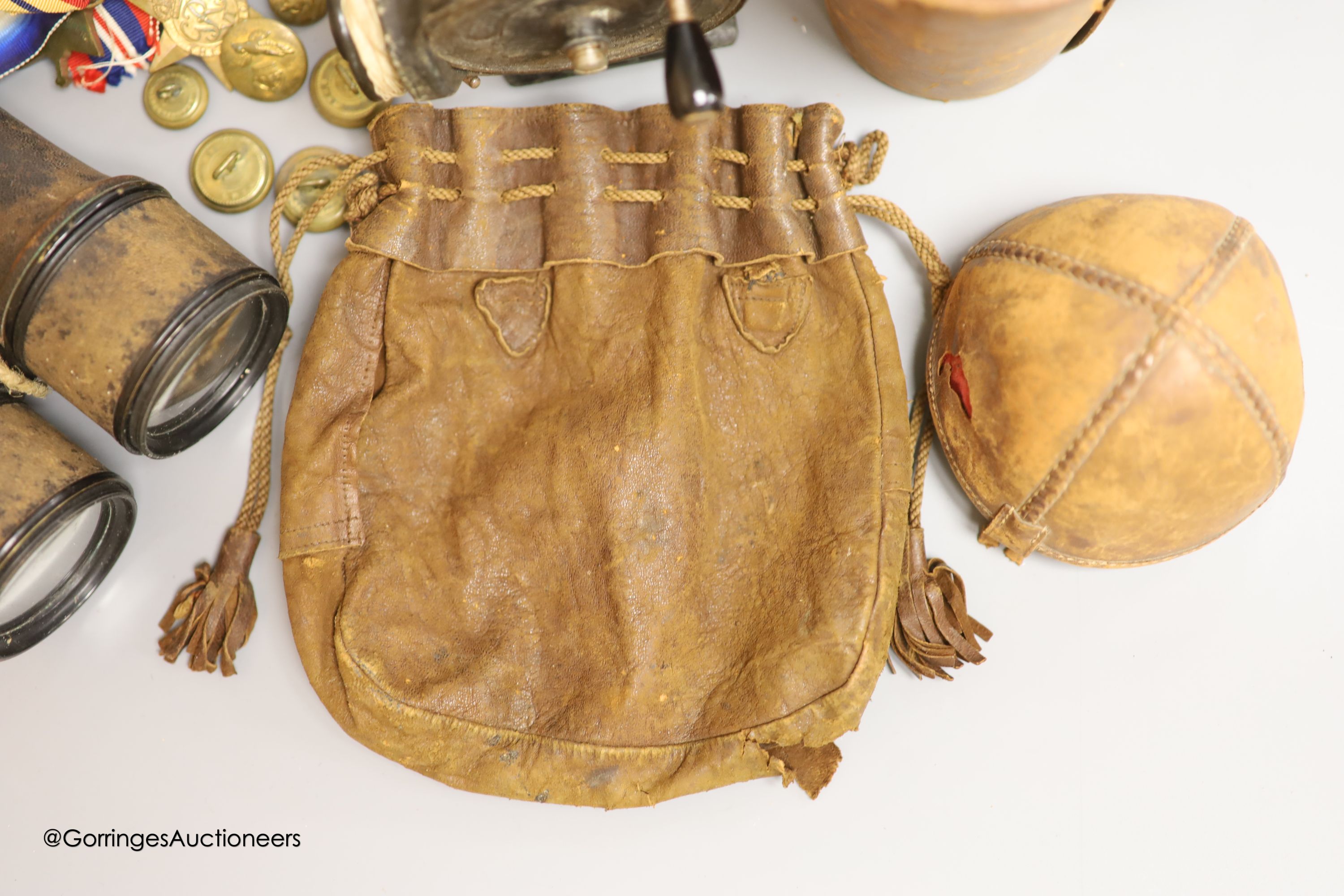 A leather cased flask and cups, various WWI and WWII medals, binoculars and a fishing reel